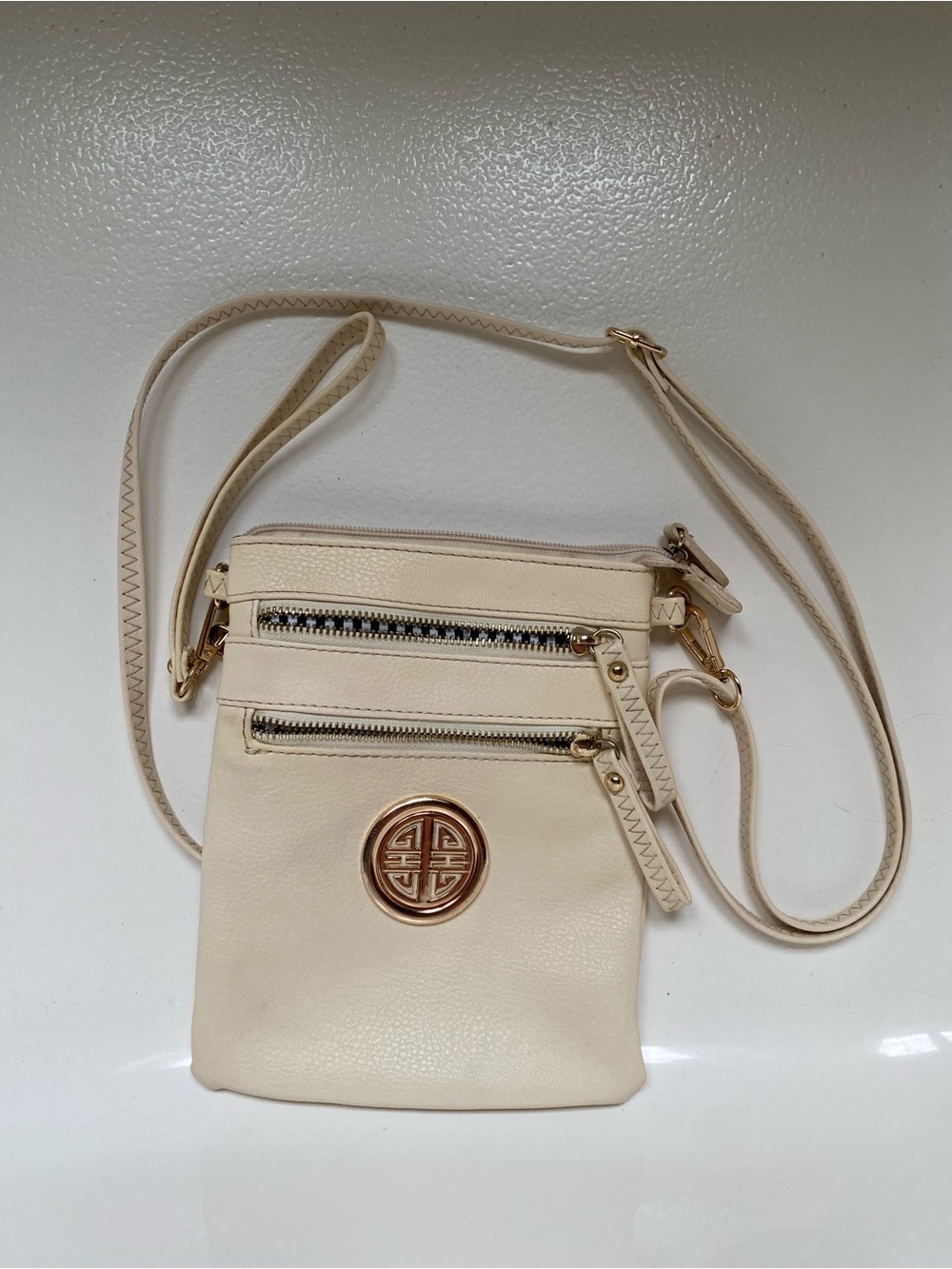 Cream Crossbody Bag with Gold Emblem